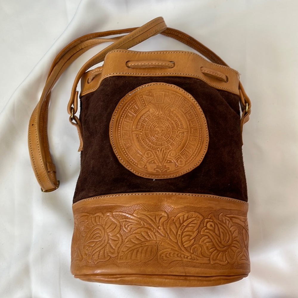 Handmade leather bucket purse. Aztec calendar and floral design.